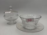 two glass bowls and a saucer on a plate with a price tag