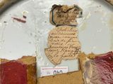 a person holding a plate with a piece of paper on it