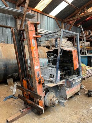 a forklift truck that is parked inside of a building
