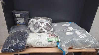 many bags of clothes on a shelf in a room