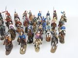 a lot of figurines that are on a white surface
