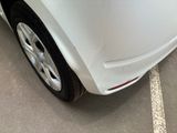 a close up of a white car parked in a parking lot