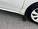 a white car that has a flat tire on the road