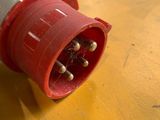 a close up of a red and white plug on a yellow table