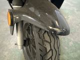 a close up of a motorcycle with a tire on the ground