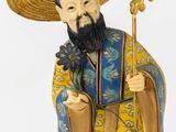 chinese figurine of a man with a hat and a cane
