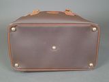 an image of a brown and tan suitcase sitting on top of a table