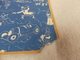 a blue book with a drawing on it sitting on the floor