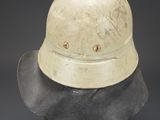 an old helmet is sitting on top of a black surface
