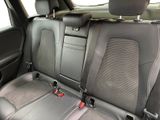 the back seats of a car are black and grey in color