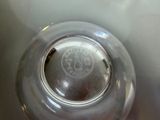 a glass bowl with a logo on it sitting on a table
