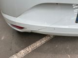 a white car with a license plate on the back of it