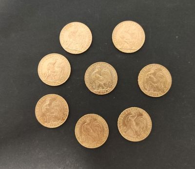 un groupe de six pièces d'or posées sur une surface noire