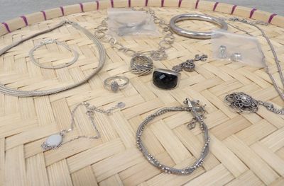 many different types of jewelry sitting on a basket