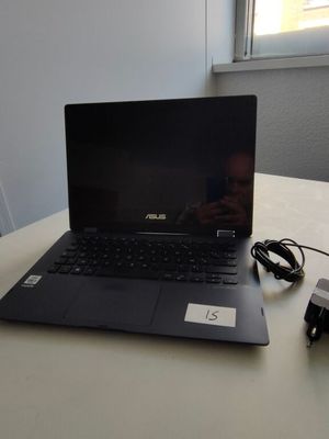 a laptop that is sitting on a table with a charger