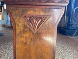 an image of a wooden pedestal with a cushion on top of it