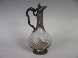 an antique silver plated glass pitcher on a white background