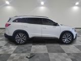 a white suv parked on a checkered floor in a garage