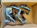 a cardboard box with a bunch of clamps in it