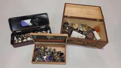 three open boxes that have various items in them