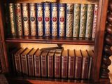 many books that are on a shelf in a book case
