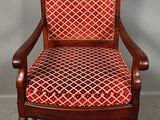a red and brown chair with a red and white patterned seat