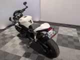 a motorcycle that is parked on a checkered floor