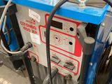 an image of a blue machine with a hose attached to it ' s side