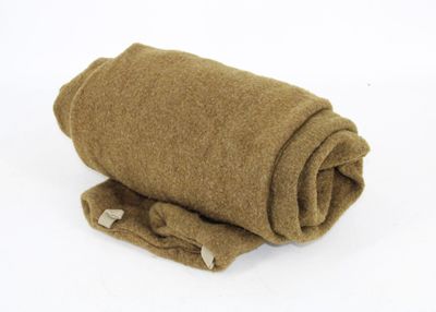 a roll of brown wool on a white surface