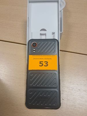 le dos d'un téléphone portable sur lequel figure un numéro, posé sur une table