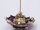 a gold plated ornament shaped like a boat