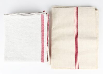 two white and red striped towels sitting on top of each other
