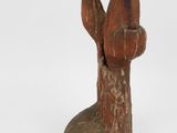 sculpture of a bird with a piece of fruit in its beak