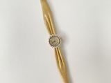 an image of a gold wrist watch with a white face on a white surface
