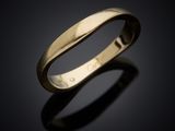 a close up of a gold ring on a black surface