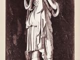 black and white photograph of a statue of a woman holding a bottle