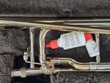 a trumpet that is laying on the ground with a tube