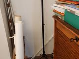 a lamp that is on a stand next to a pile of books
