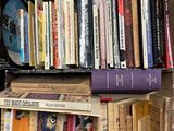 many books that are on a shelf in a box