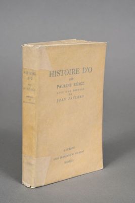 an old book sitting on top of a table on a gray surface