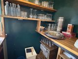 a small kitchen with a lot of glassware on the shelves