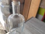 a glass bottle with a wooden stopper on a table