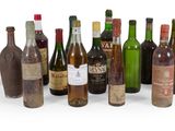 many bottles of wine that are lined up in a row
