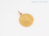 an image of a gold coin with a bird on it on a white surface