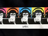 a skateboard that has a picture of a man with headphones on it