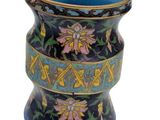 a blue vase with a design of flowers on it
