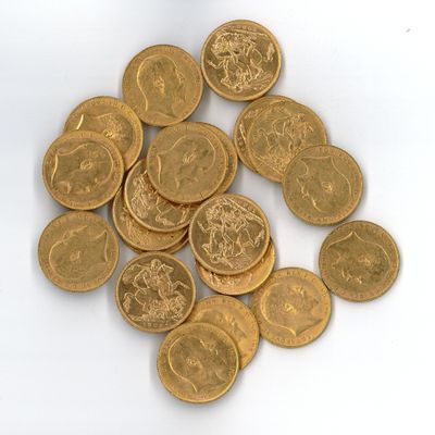 a pile of gold coins sitting on a white surface