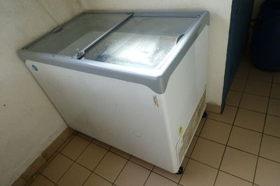 un petit congélateur qui se trouve dans un coin de la pièce
