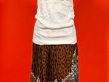 a mannequin with a white top and a leopard print skirt
