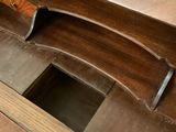 a close up of a wooden table with a knife in it